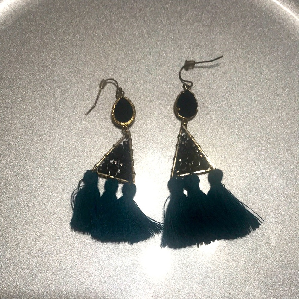 A pair of earrings with many parts to it like rocks and more